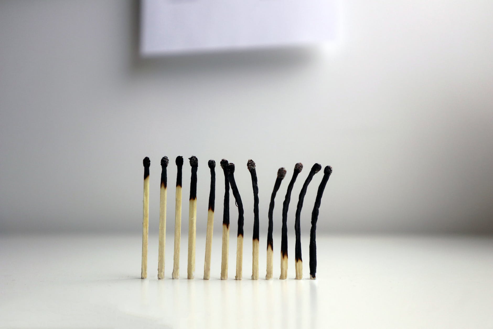 a row of matches, which are gradually more and more burnt away